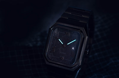 Monarch carbon black dial watch featuring date display and refined retro geometric design aesthetics