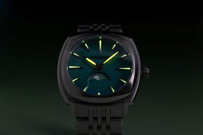 Lucent moon phase silver watch with a teal green dial, luminous needles and marks.