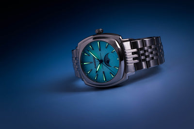 Lucent moon phase silver watch with a baby blue dial, luminous needles and marks.