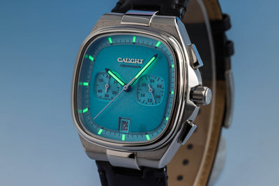 Aeris baby blue showcasing subdials and six o'clock date window with luminous hands and markers