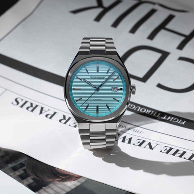EPOCH Baby Blue Watch With Time Aged Cigar Roll Dial On Newspaper Featuring Polished Stainless Steel Finish