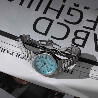 EPOCH Baby Blue Vintage Style Watch On Newspaper Featuring Polished Stainless Steel Dial And Timeless Design